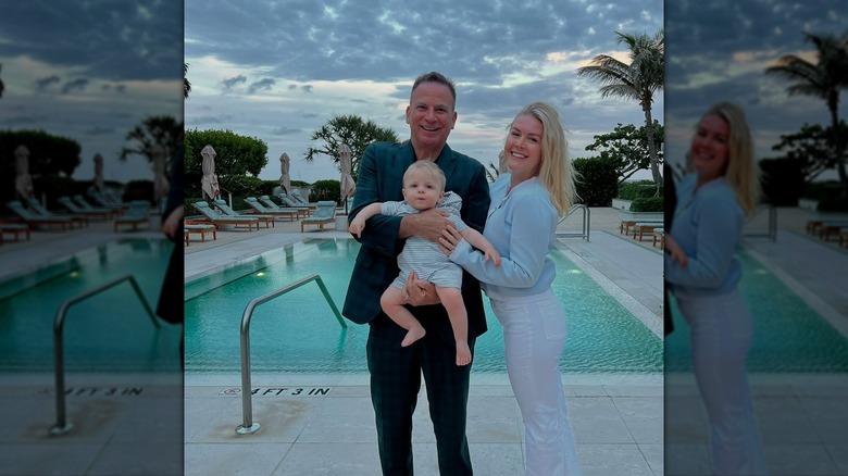 Karline Leavitt and Nicholas Riccio smiling while holding their son