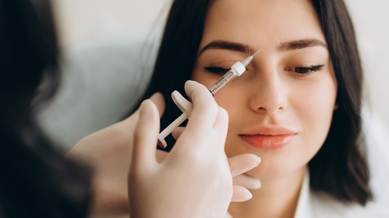 Woman getting Botox in forehead