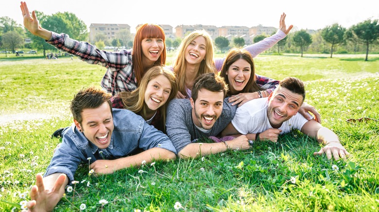 young people laying out on grass