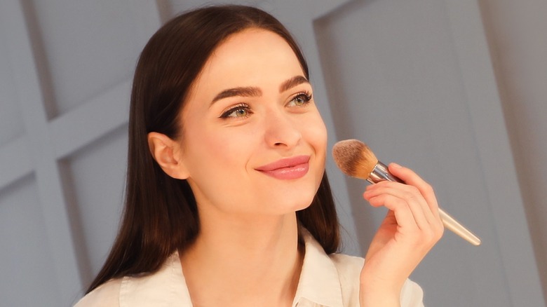 woman applying makeup