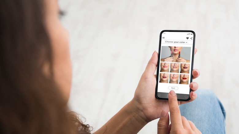 Woman uses virtual makeup testing on phone