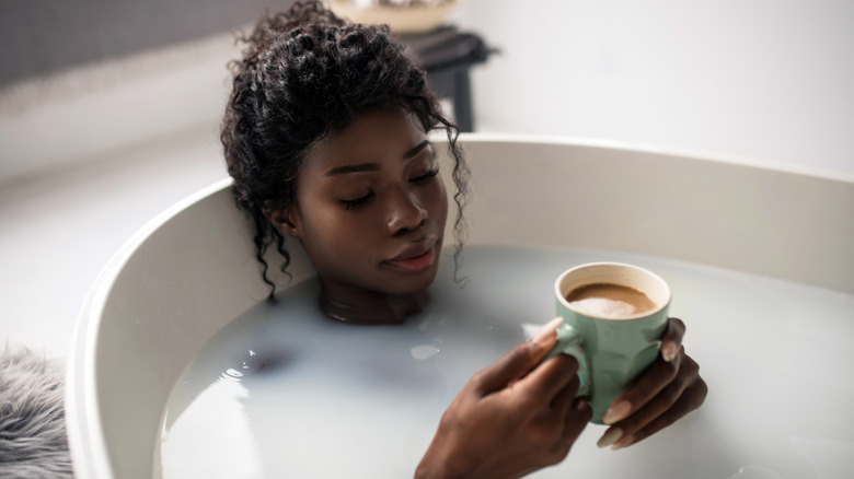 woman having coffee in tub