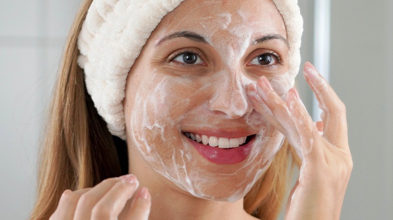 woman exfoliating her skin