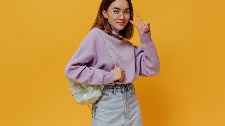 Purple sweater and denim skirt