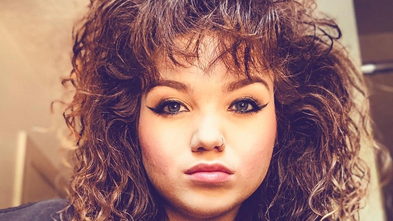 Girl with curly mall bangs