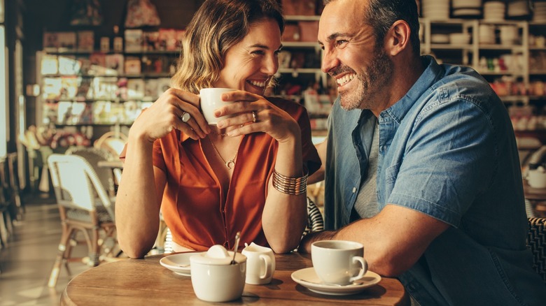 Couple laughing in coffee shop