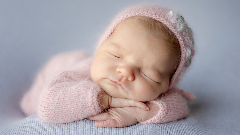 Baby girl sleeping on her hands