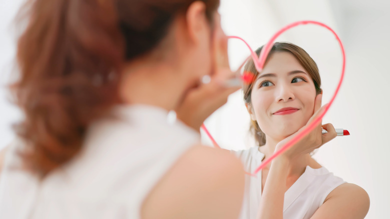 Woman looking confidently in the mirror.