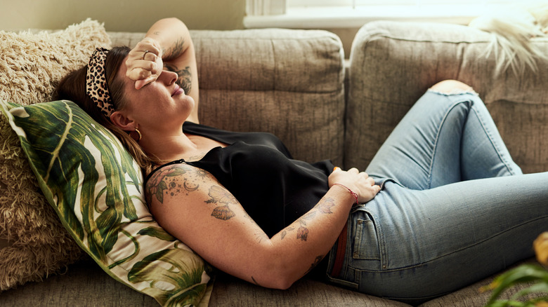 A woman at home suffering on the couch