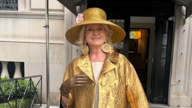 Martha Stewart wearing a gold hat