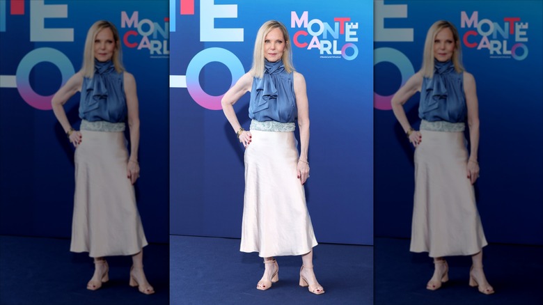 Melissa Sue Anderson poses wearing a beige satin skirt and a blue ruffled blouse