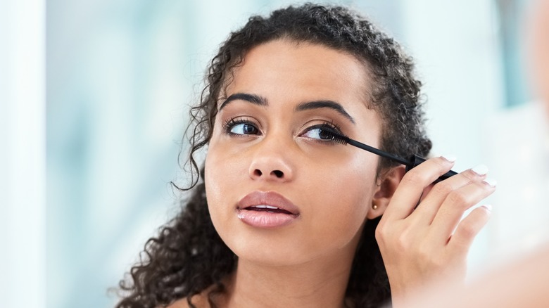 Woman applying mascara