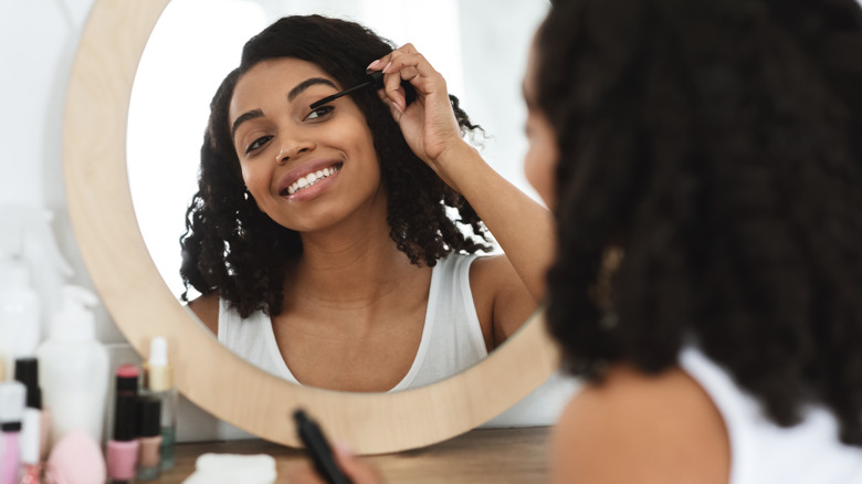 woman applying mascara