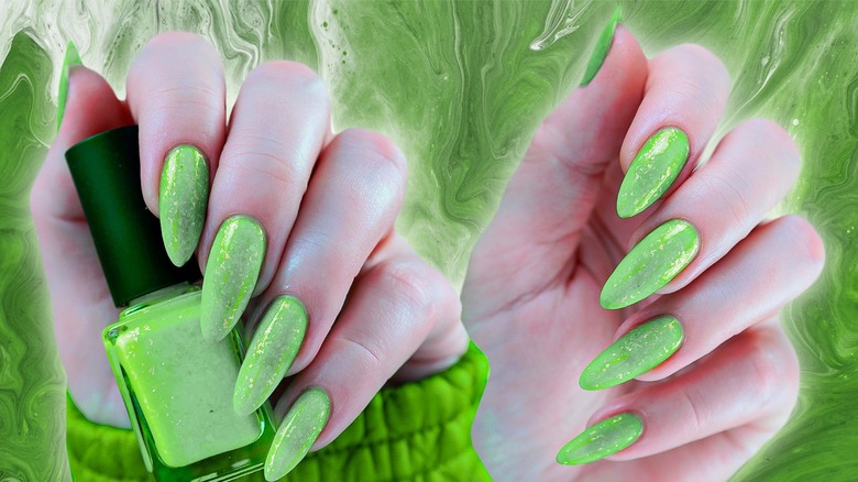 Green manicure on green background