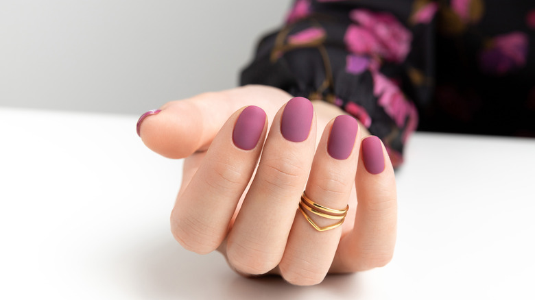 woman with burgundy nails