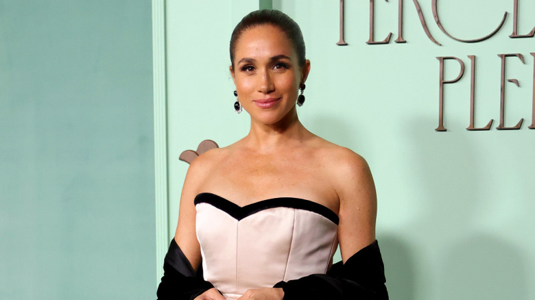 Meghan Markle posing in a caffiene dress at the 15% pledge event