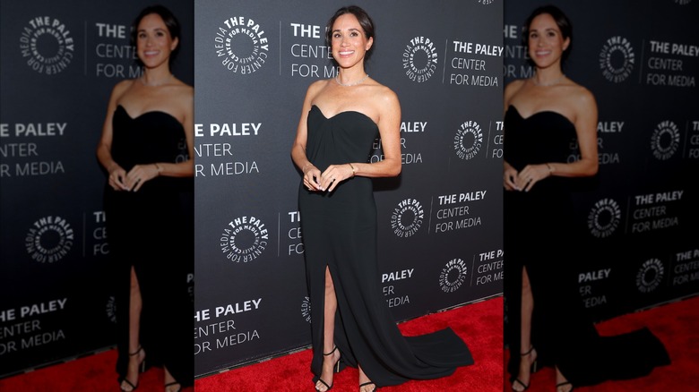Meghan Markle wearing a black dress at the The Paley Center for Media red carpet