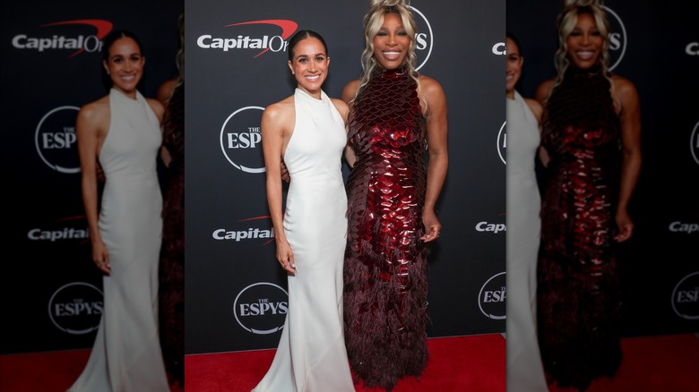 Meghan Markle wearing a white dress poses beside Serena Williams at the ESPY Awards