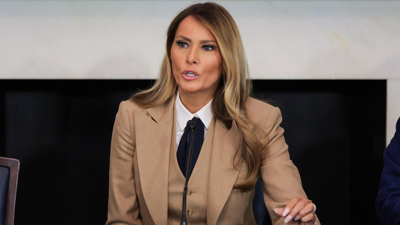 Melania Trump wearing a brown pantsuit photographed while speaking at an event