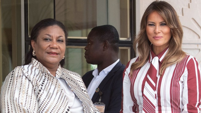 Melania Trump wearing a red-and-white outfit at a hospital in Ghana