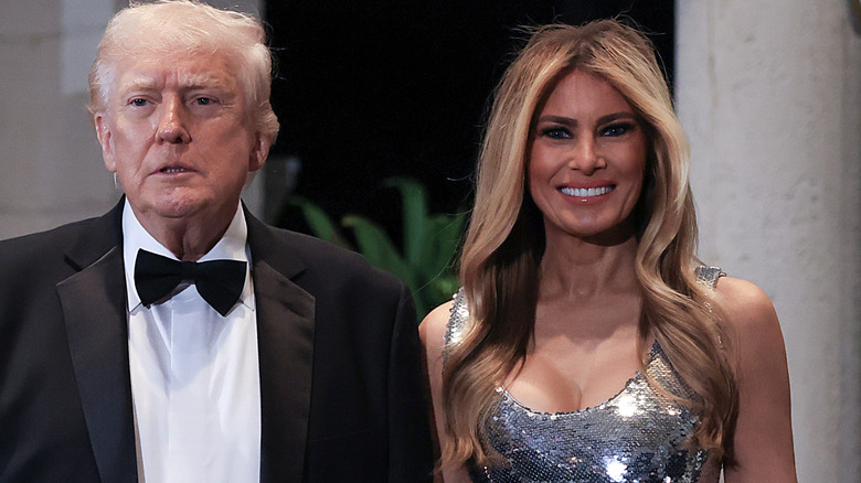 Melania Trump in a silver dress standing next to Donald Trump