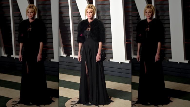 Melanie Griffith smiles wearing a black gown