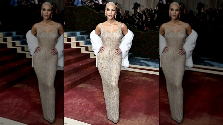 Kim Kardashian poses with her hands on her hips at the 2022 Met Gala