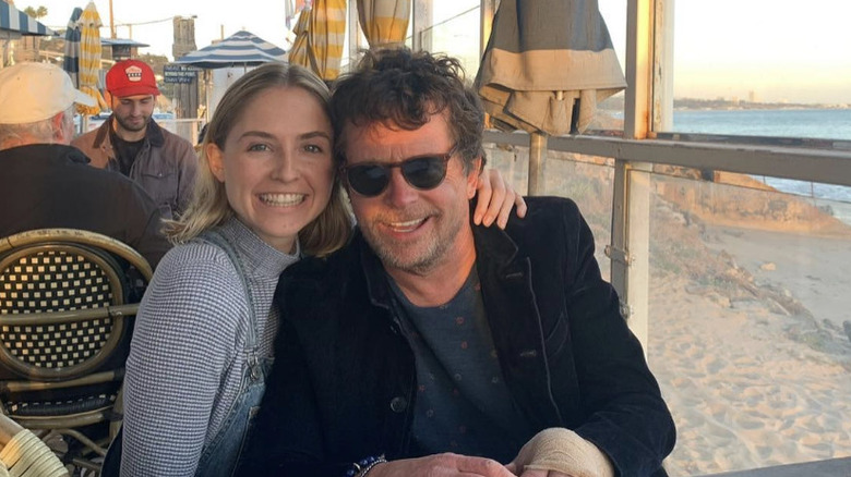 Michael J. Fox and his daughter Schuyler Fox smile for a photo while sitting together at a restaurant