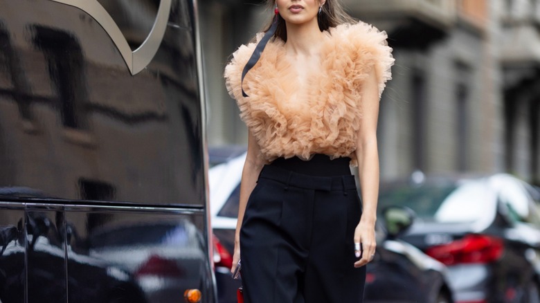 Woman wearing beige ruffled top