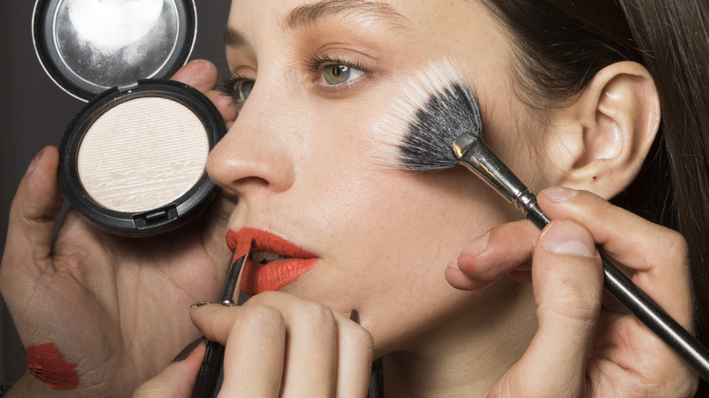 woman getting makeup applied