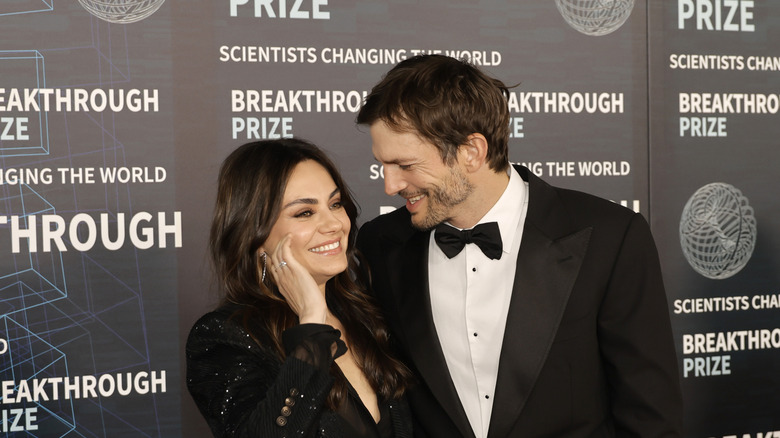 Mila Kunis and Ashton Kutcher laughing