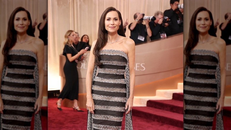 Minnie Driver on the Golden Globes red carpet in a strapless striped dress with sleek, straight hair.