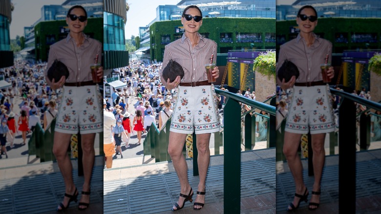Minnie Driver posing at Wimbledon in 2026 in a casual outfit with her hair pulled back.