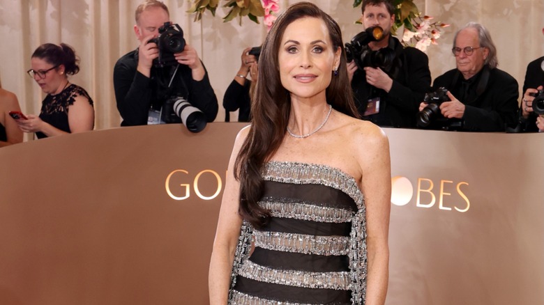 Minnie Driver posing at the Golden Globes in a black-and-silver striped dress.