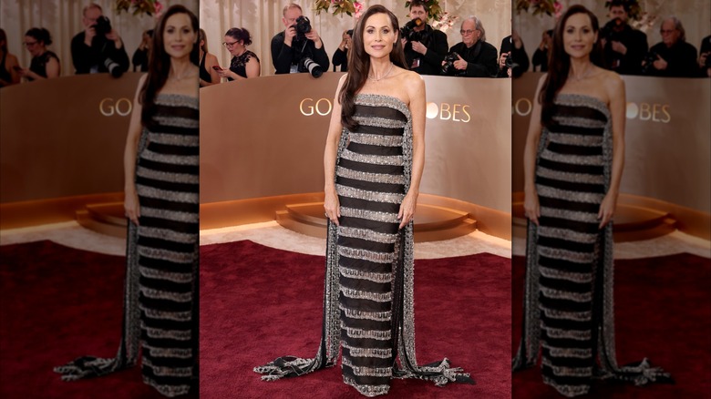 Minnie Driver on the Golden Globes red carpet wearing a black-and-silver striped dress.