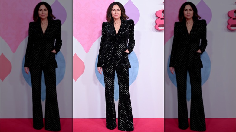 Minnie Driver on the red carpet wearing a black-and-white polka-dot suit.