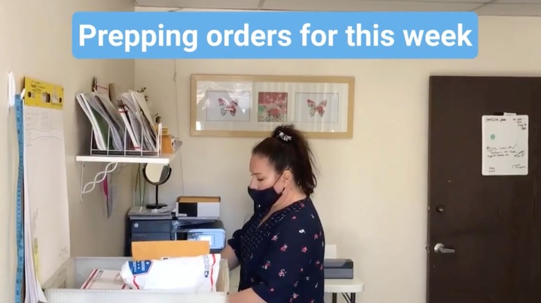 An employee at Mirai Clinical packing orders.