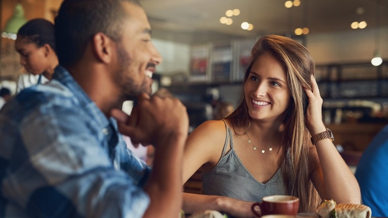 Woman smiling at man 