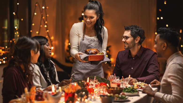 Woman serves holiday dinner