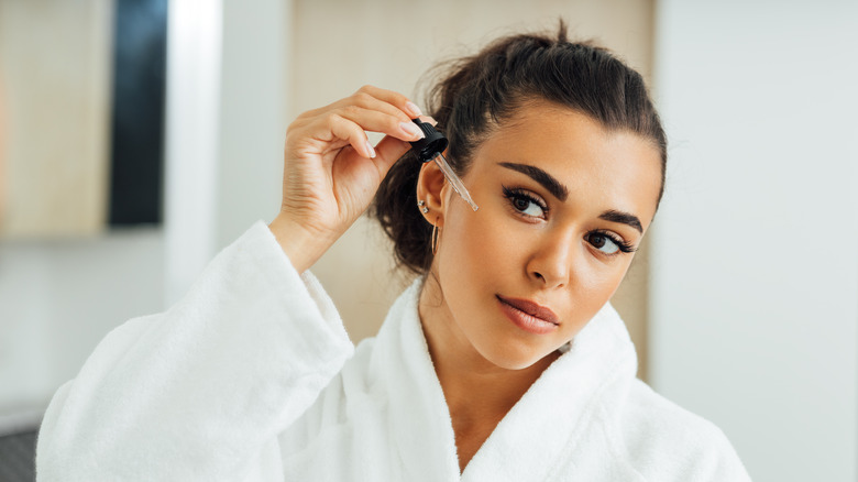 Woman applying serum