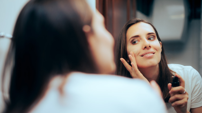 Woman applying foundation