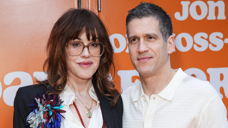 Molly Ringwald and Panio Gianopoulos posing together at a premiere.