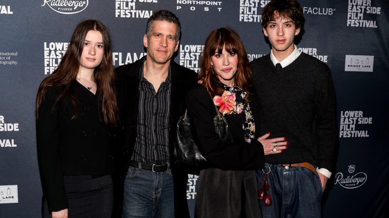 Panio Gianopoulos and Molly Ringwald posing with their children Adele Georgiana Gianopoulos and Roman Stylianos Gianopoulos at a red carpet event.