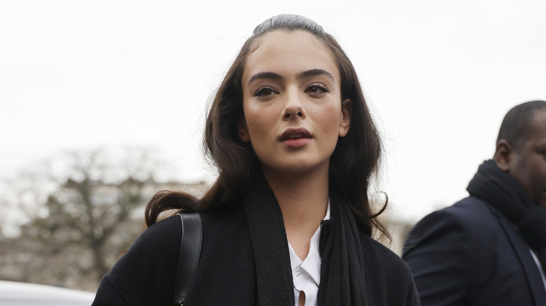 Deva Cassel wearing simple makeup and a peacoat outside.