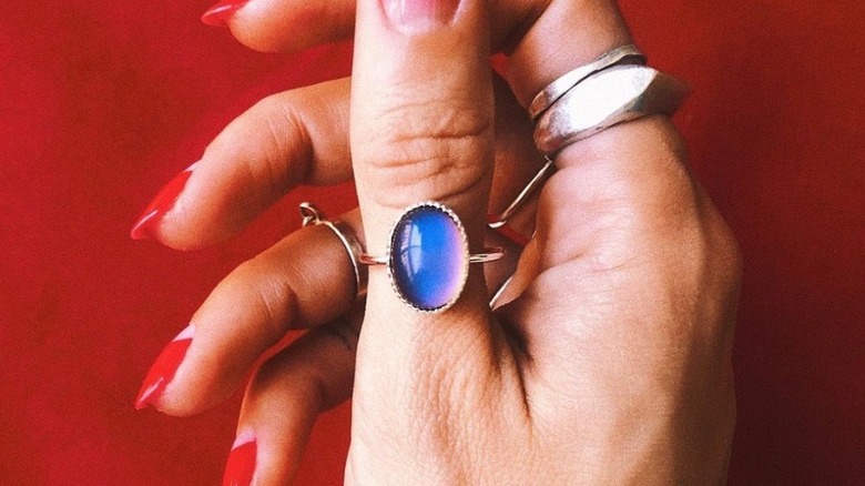 Hand with blue mood ring