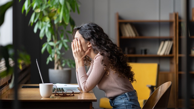 tired woman sitting at desk