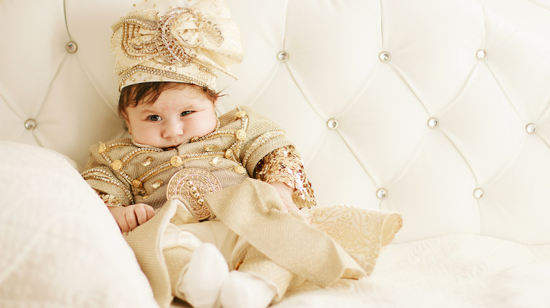 Baby dressed as prince.