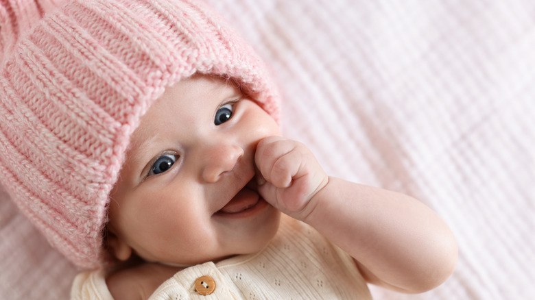 Baby with pink knitted hat.