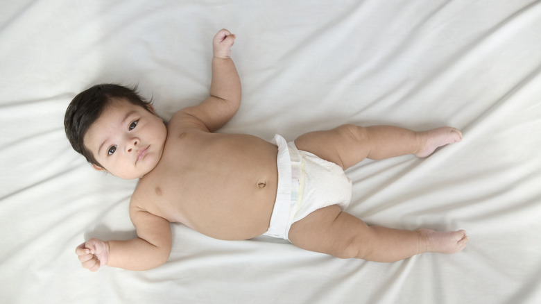 Baby laying down in diaper.