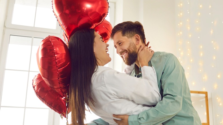 couple with heart-shaped balloons